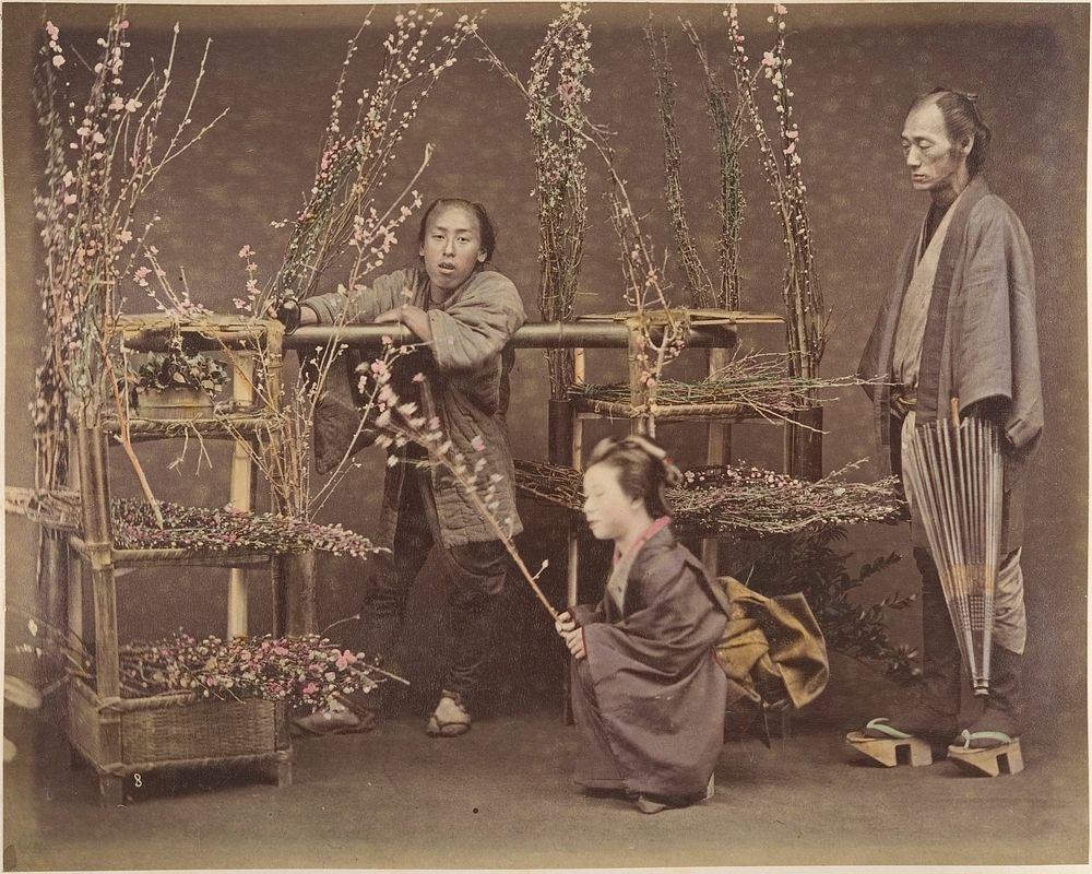 Two Japanese Men and One Japanese Woman Posing with Flowering Branches  by Unknown