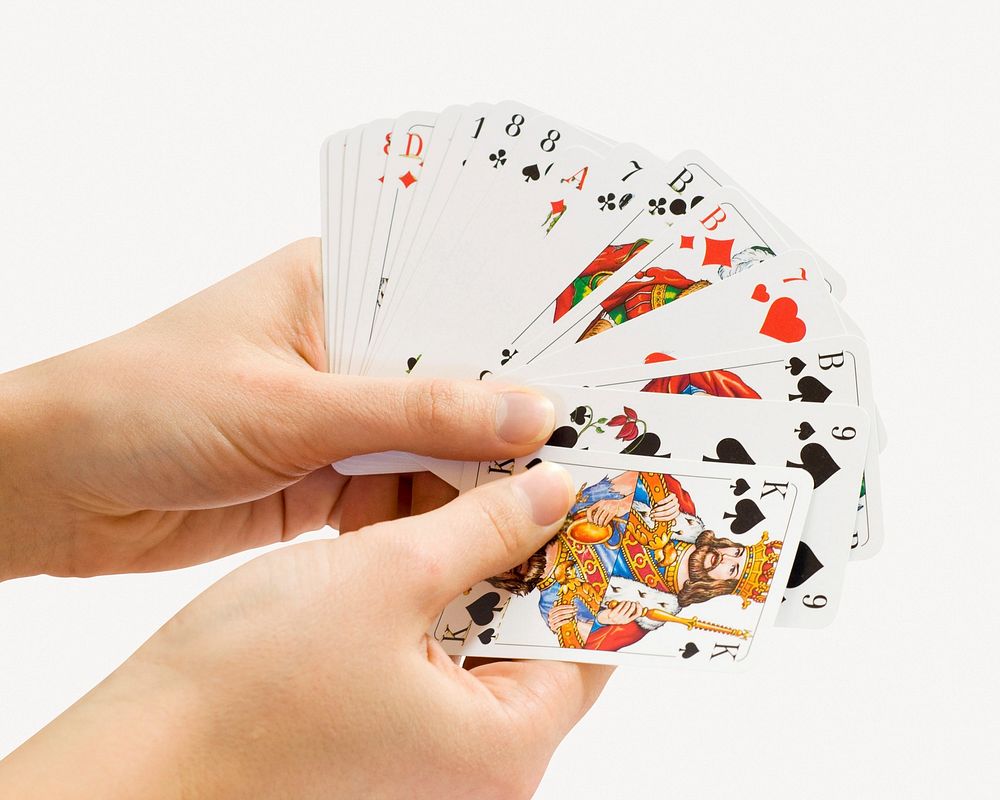 Hands holding playing cards psd