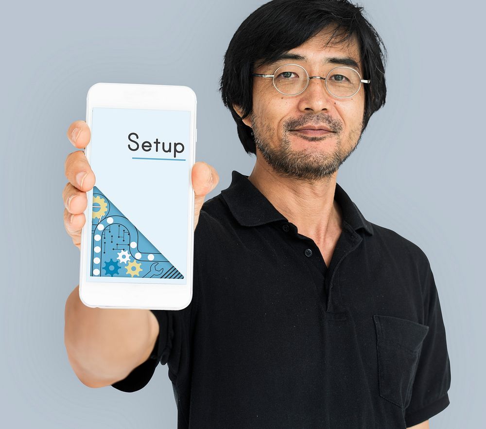 Asian man showing smart phone with setup word on hand