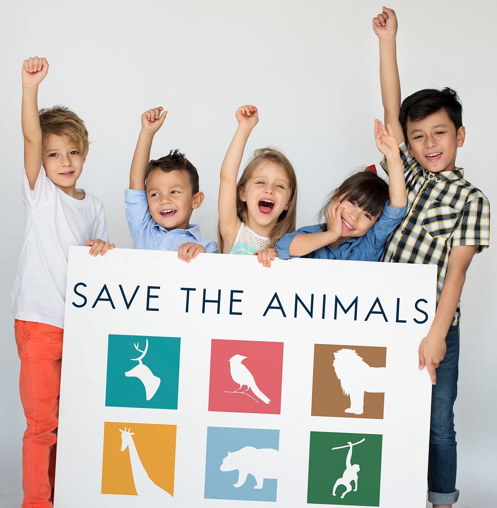 Young kids holding a save the animals banner