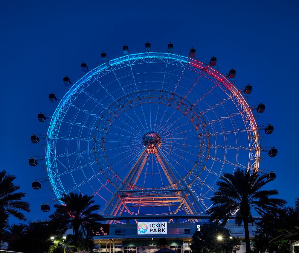                         The Wheel, a 400-foot-high (or 40-story), neon-lit Ferris wheel at dusk in ICON Park, a 20-acre…