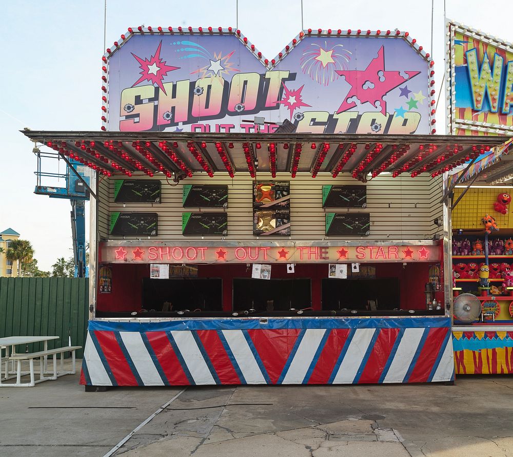                         Carnival-style shooting-gallery game booth at the vintage Old Town Kissimmee amusement park, built…