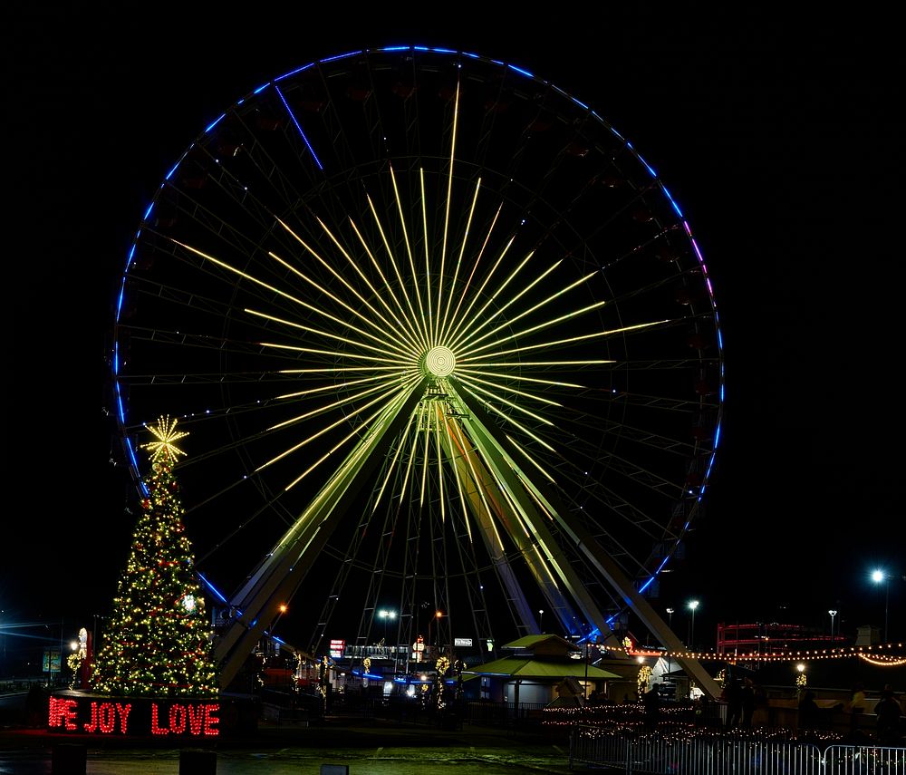                         The signature "United We Stand" Christmas tree, next to the attraction's giant Ferris wheel in…