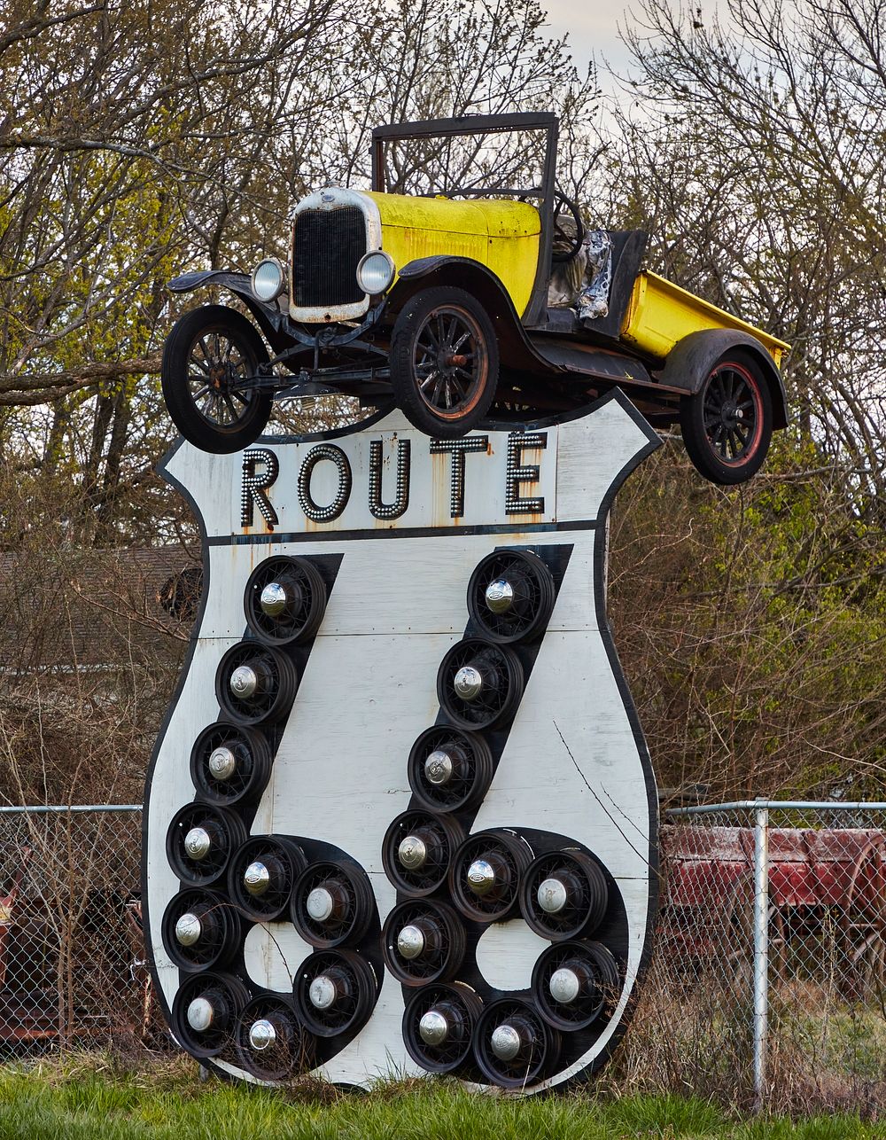                         An old but interesting truck is perched atop an illuminated sign for historic U.S. highway 66 in…