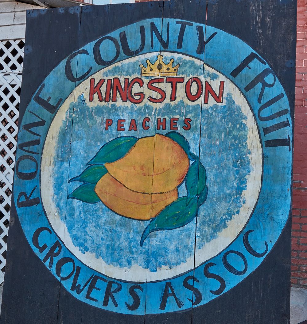                         An artistic wooden sign plugging the local peach-growing industry in Kingston, Tennessee, a small…