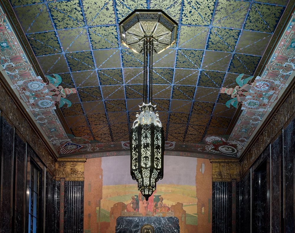                         One of two massive, two-ton bronze chandeliers that hang inside the two-story-high Memorial Hall of…