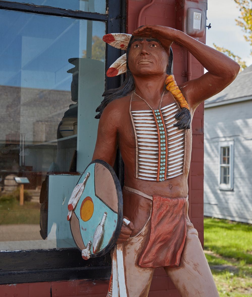                         A Native American scout-like figure outside the Furnburg Store, a frontier general store built near…