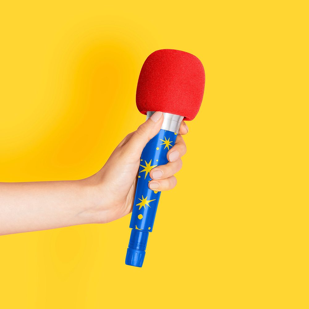 Hand holding a microphone, karaoke photo