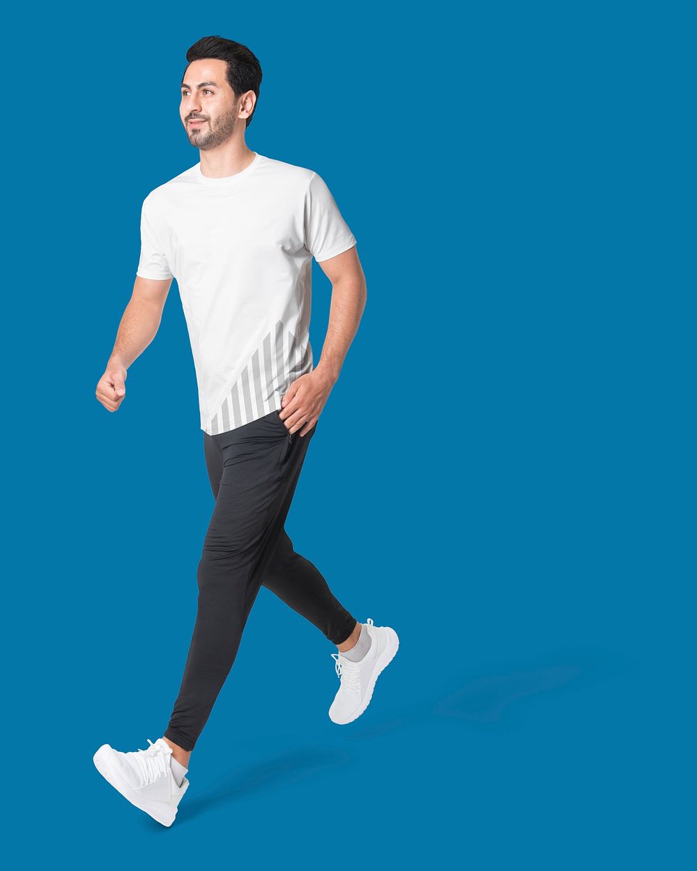 Sporty man walking in t-shirt and sweatpants, full body