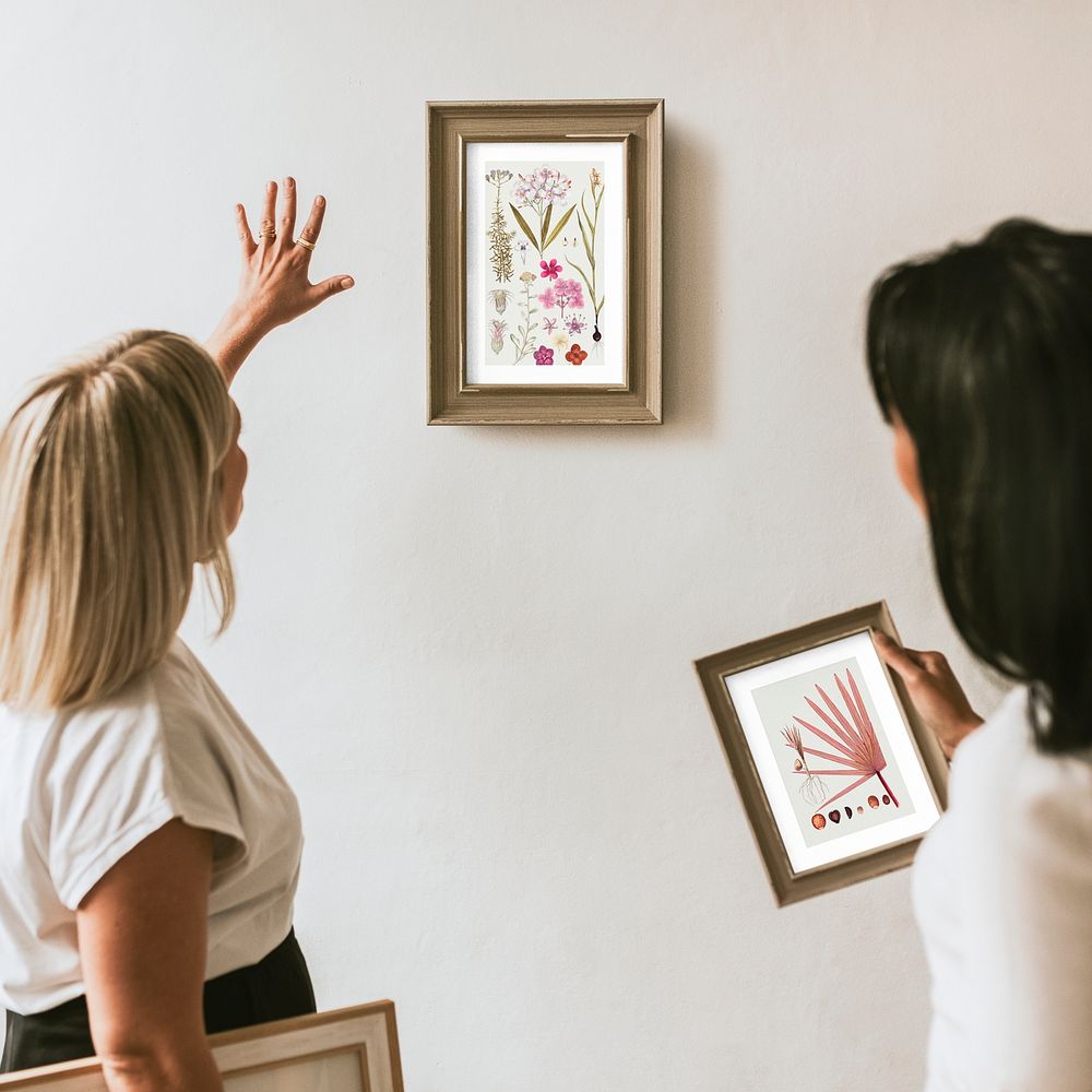 Photo frame mockup, women decorating wall psd