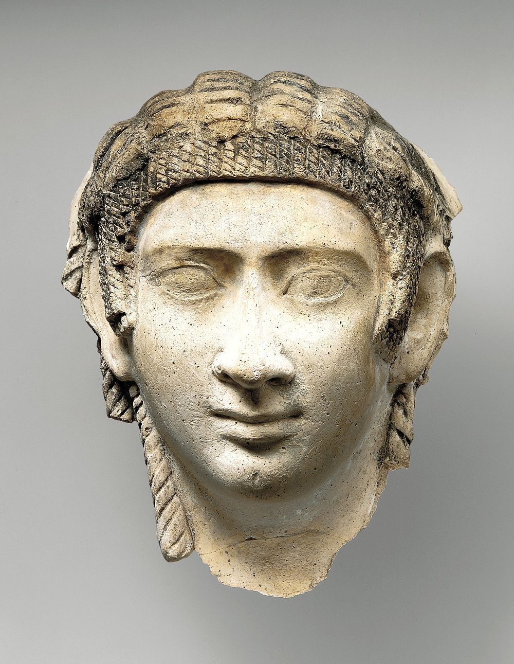 Mask of a woman with corkscrew locks and bang