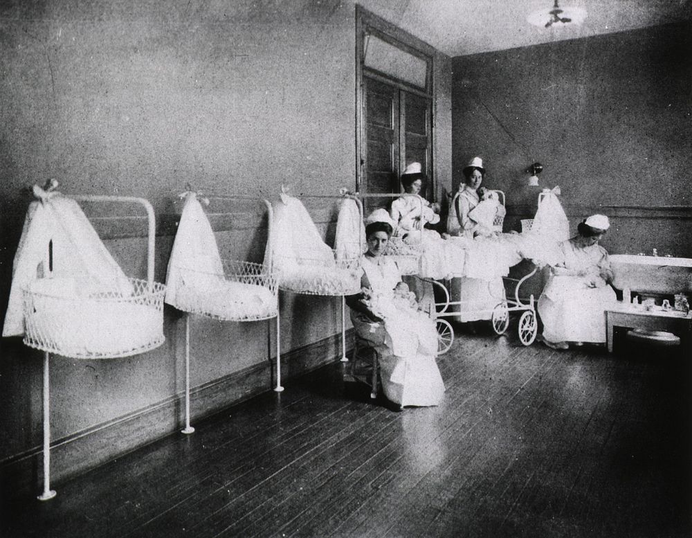 Hospitals - Pediatrics: Nurses holding infants at the New York infirmary for women and children (1913). Original public…