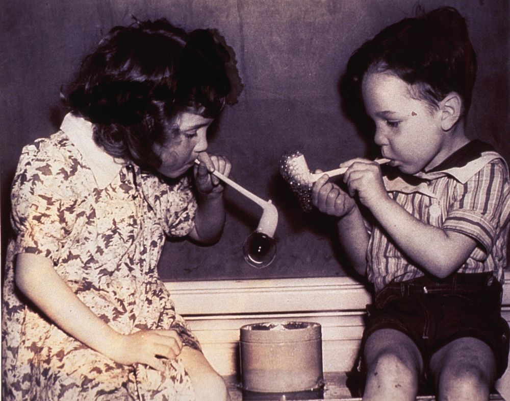 Nursery school. A little girl and a little boy are blowing bubbles. Original public domain image from Flickr