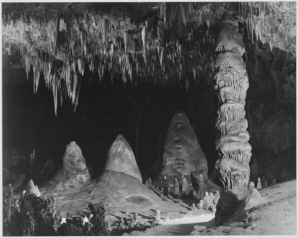 "Two people in background, 'The Rock of Ages in the Big Room,' Carlsbad Caverns National Park," New Mexico. Photographer:…