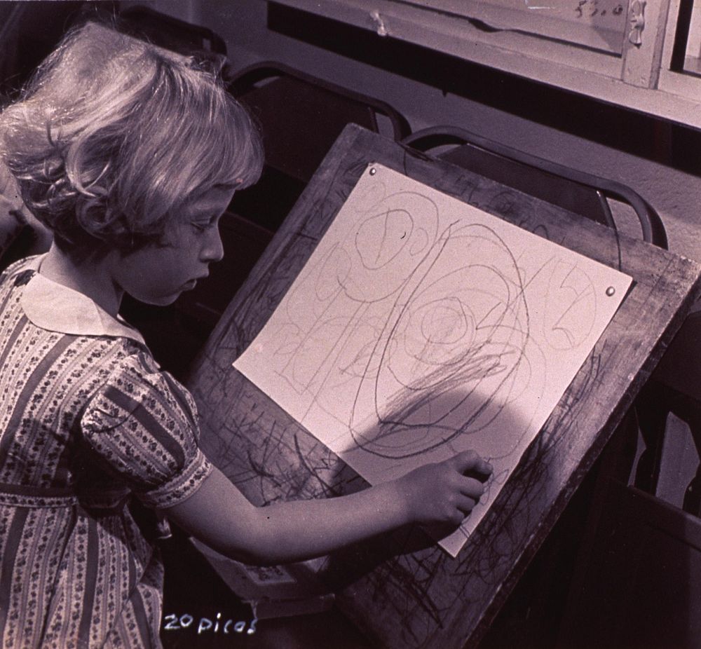 Nursery school. A girl is drawing.Original public domain image from Flickr