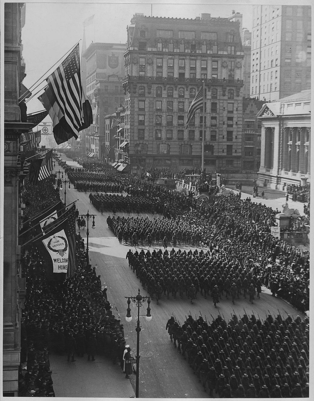 Overseas men welcomed home. Parade in honor of returned fighters passing the Public Library, New York City. Original public…