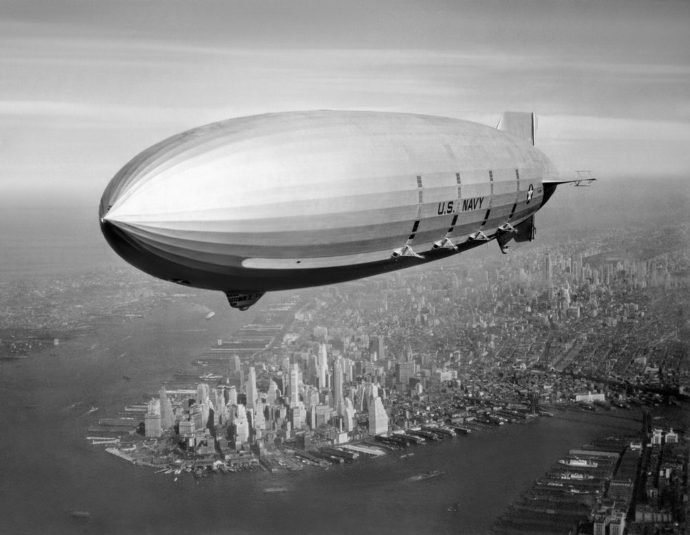 Photo-enhanced version of USS Macon (ZRS-5) Flying over New York Harbor, circa Summer 1933. The southern end of Manhattan…