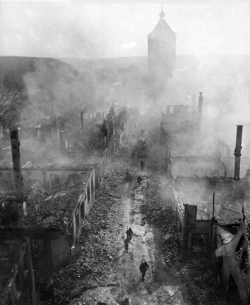 "Infantrymen of the 255th Infantry Regiment move down a street in Waldenburg to hunt out the Hun after a recent raid by 63rd…