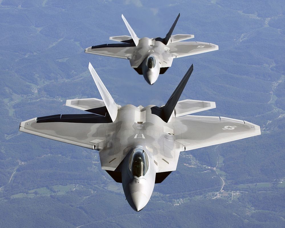 Lt. Col. James Hecker (front) and Lt. Col. Evan Dertein line up their F/A-22 Raptor aircraft behind a KC-10 Extender to…