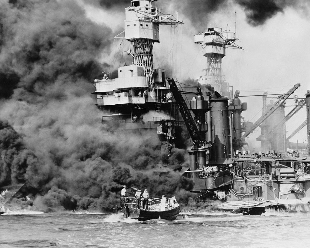 "Pearl Harbor, Hawaii. A small boat rescues a seaman from the 31,800 ton USS West Virginia (BB-48), which is burning in the…