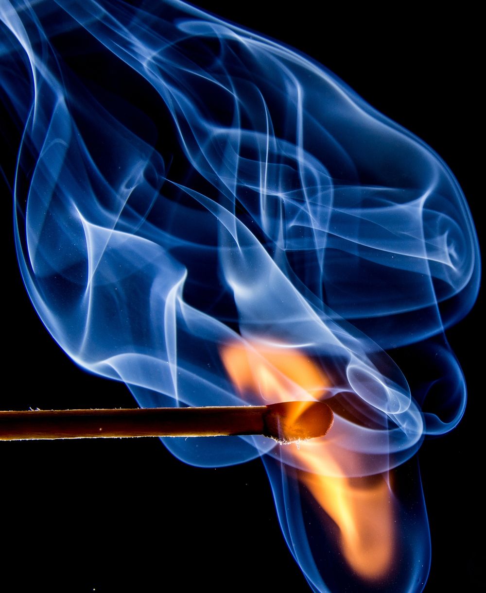 Lighting a match, blue flame, closeup. View public domain image source here