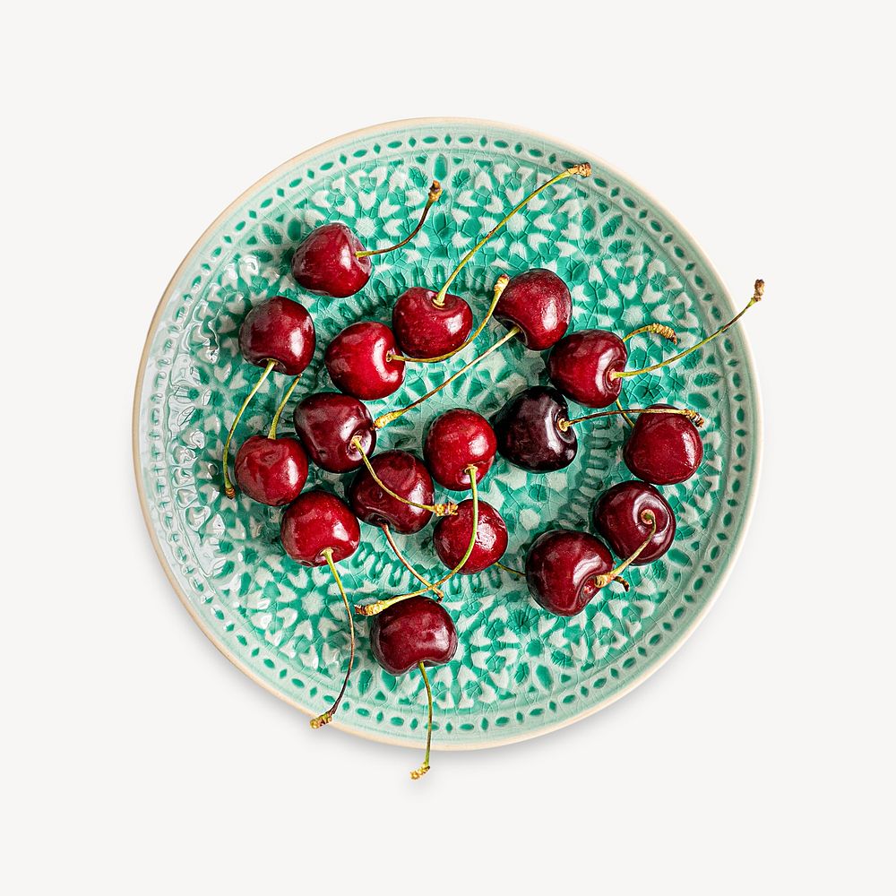Fresh cherries on a green plate flatlay