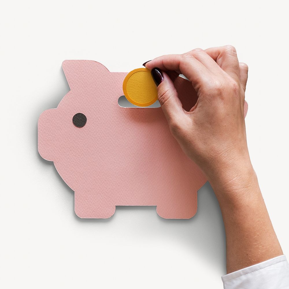 Hand lodging coin into piggy bank isolated image