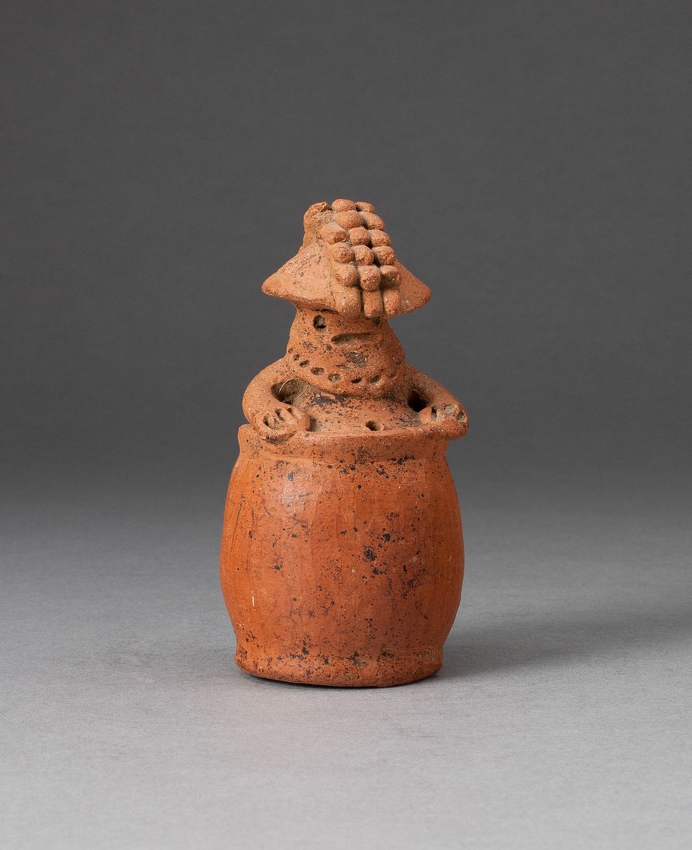 Miniature Rattle in the Form of a Figure Wearing Headdress and Mask by Guacimo