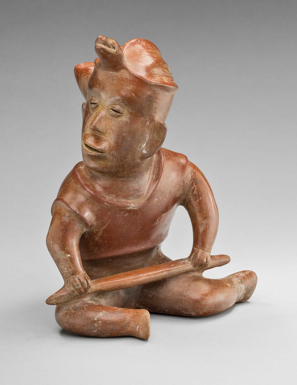 Seated Warrior Figure with Turtle Headdress, Holding a Staff by Colima