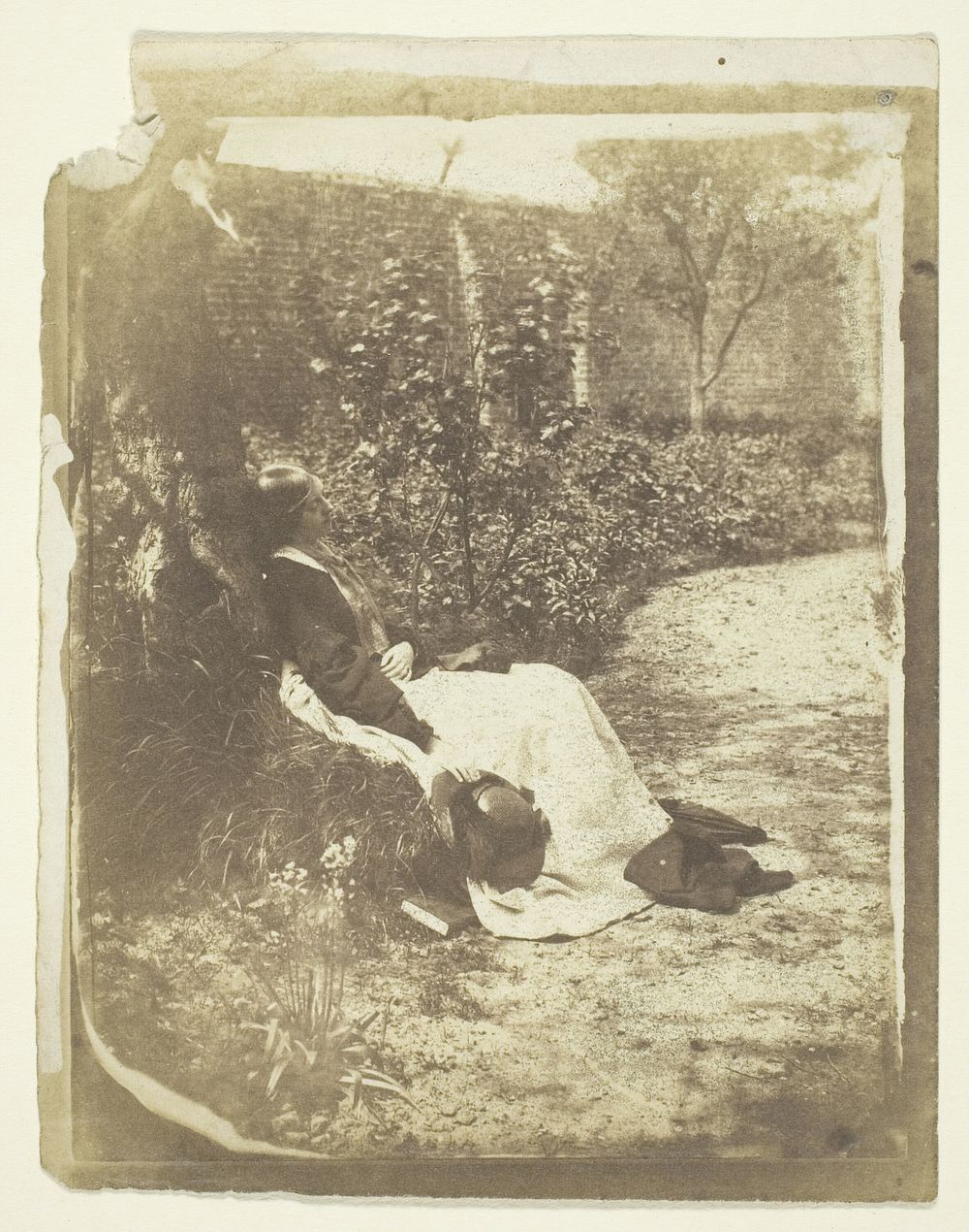 Mrs. Craik Reclining in Garden with Hat and Book by Unknown