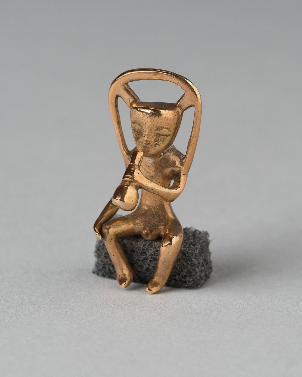 Pendant in the Form of a Seated Musician by Veraguas