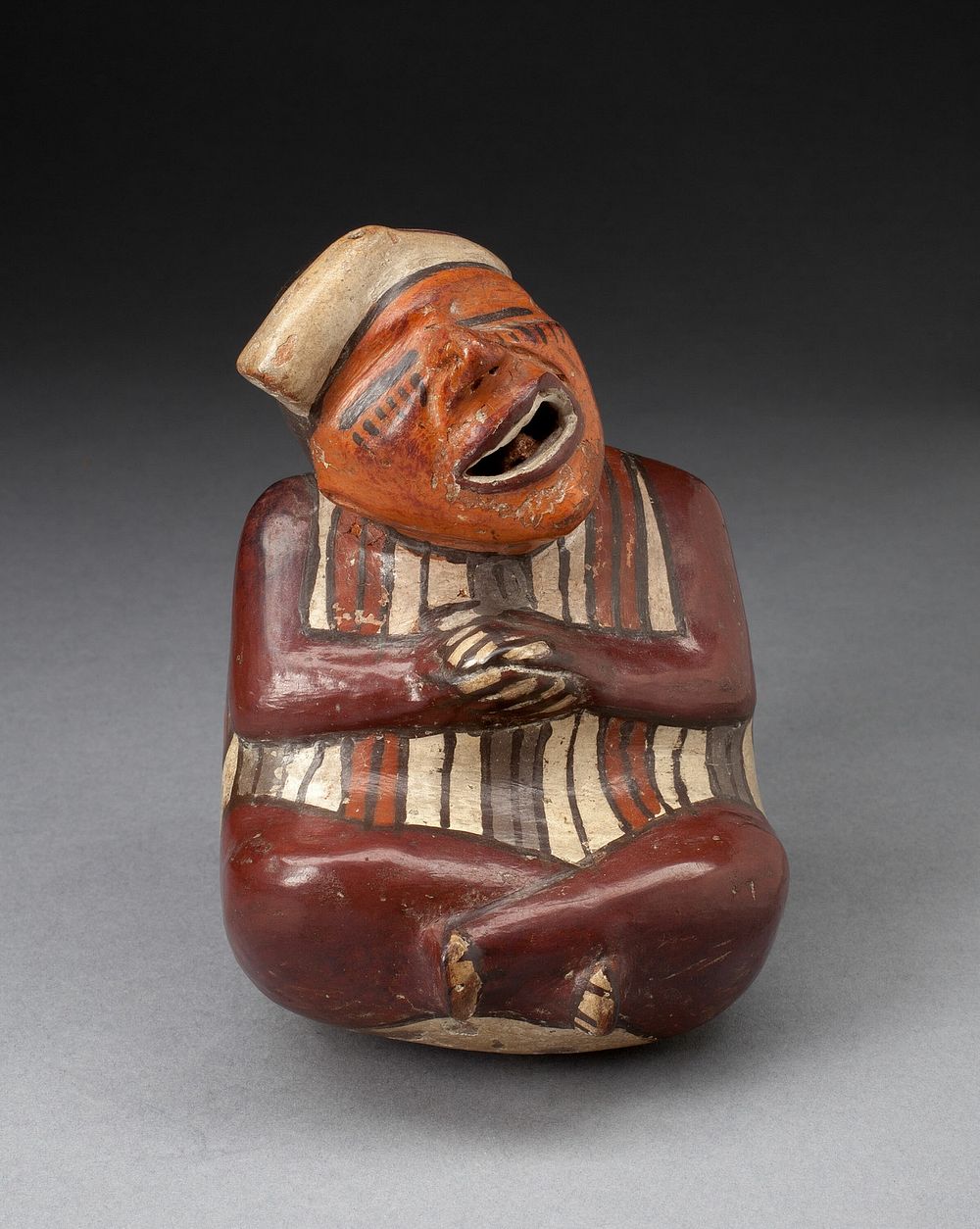 Single Spout Vessel in the Form of a Crossed-Legged Figure, Probably Deceased by Nazca