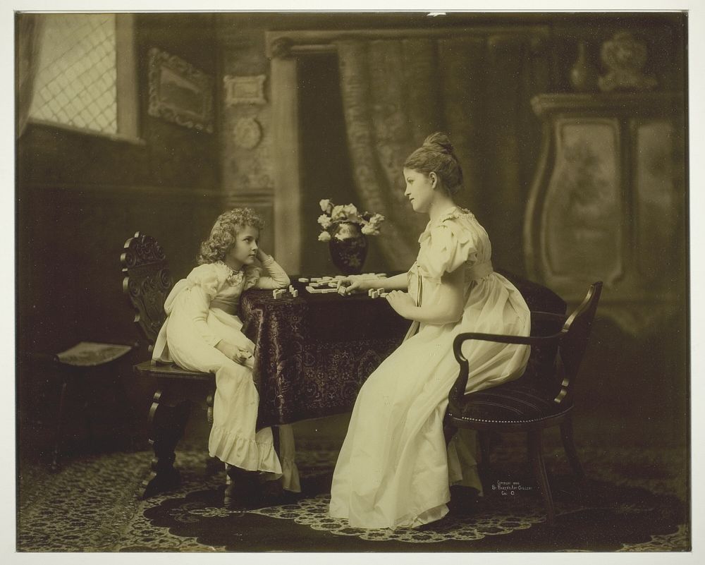 Woman and Child Playing Dominoes at Table by Unknown