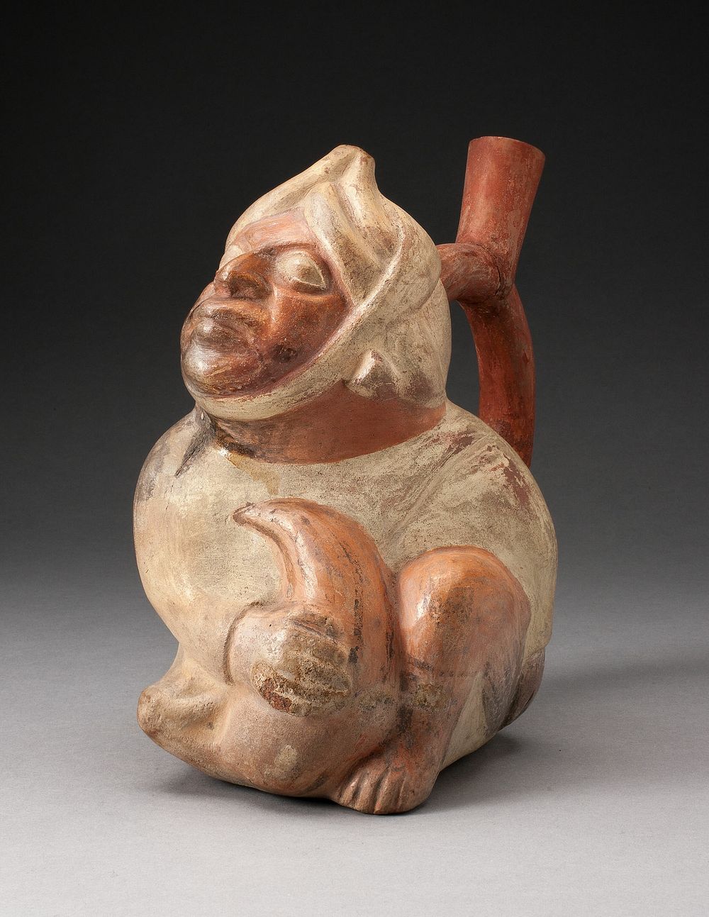 Handle Spout Vessel in the Form of a Seated Man by Moche