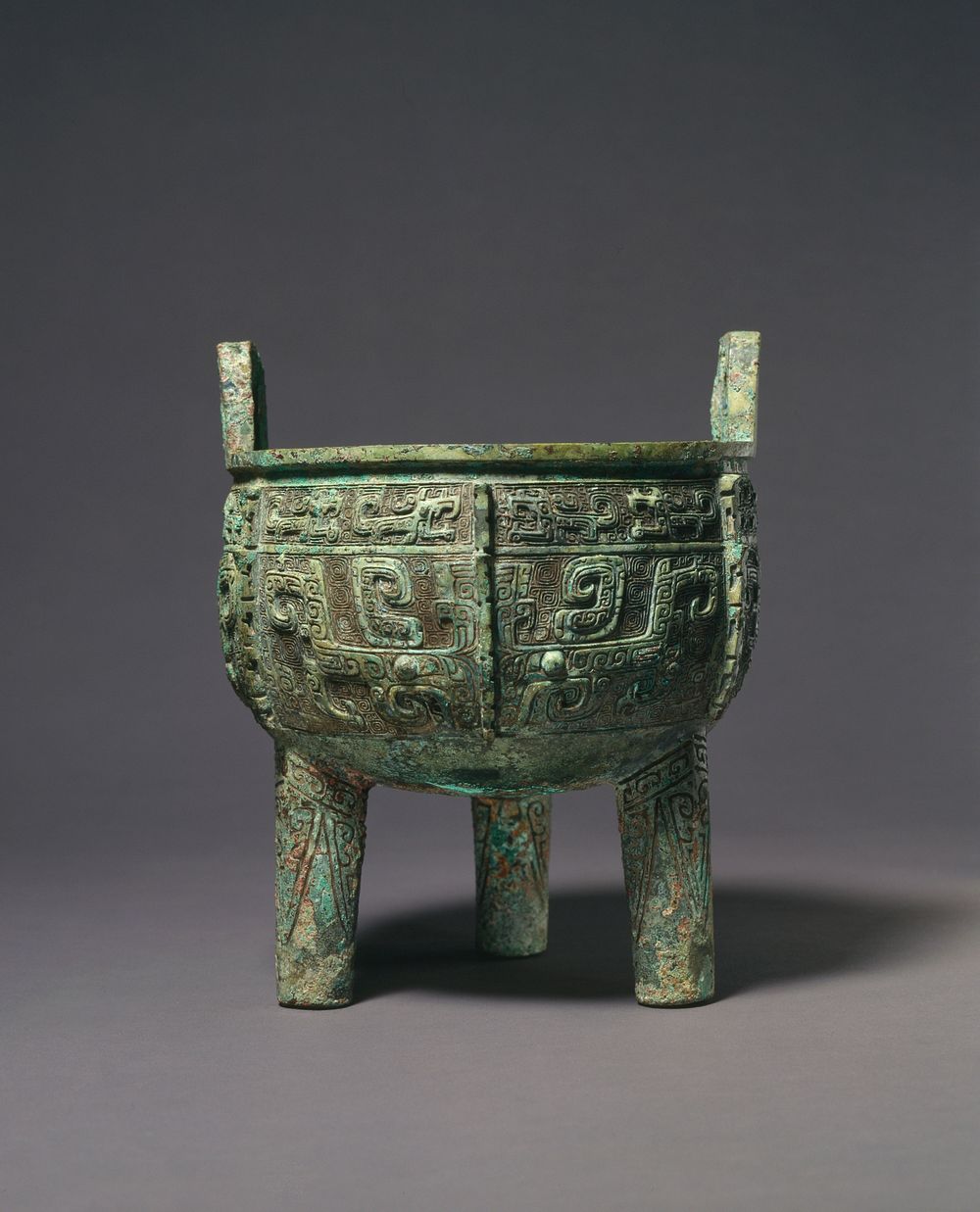 Tripod Food Vessel (ding) with Design of Zoomorphic Masks, Dragons, and Spiral Patterns