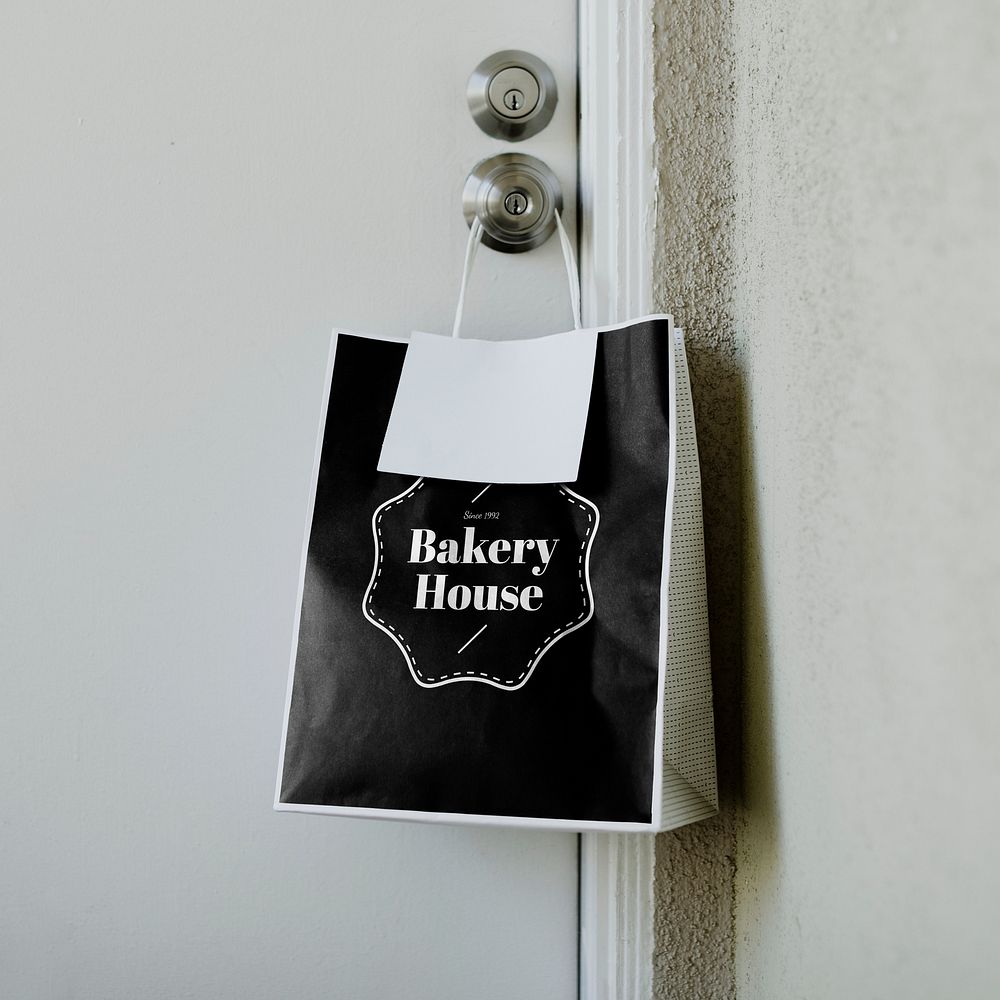Contactless delivery bakery bag mockup hanging on a door knob during the coronavirus pandemic