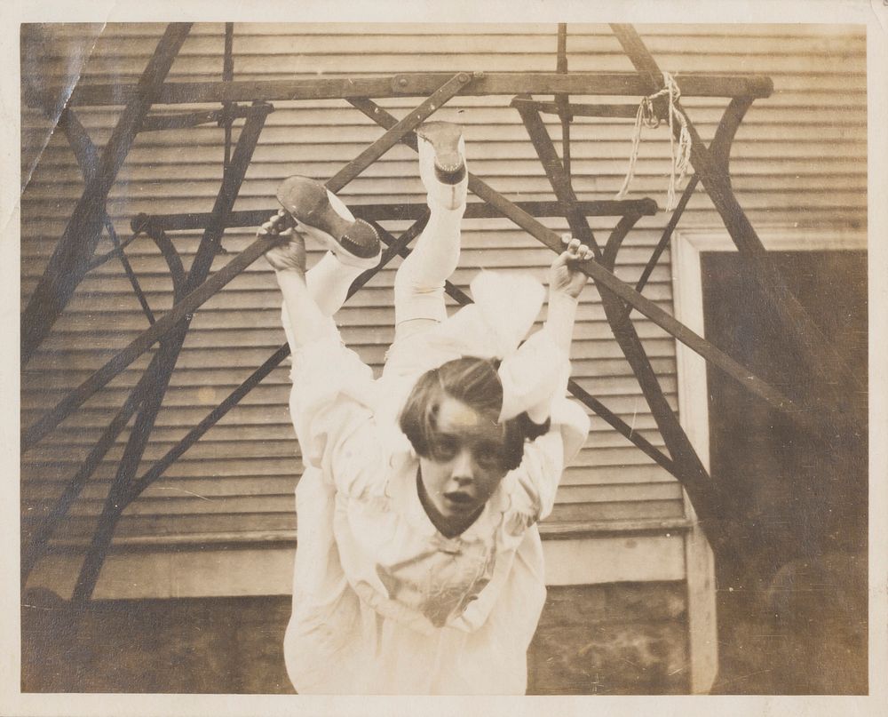 Untitled (Girl with Large Bow in Hair Hanging from Junglegym)