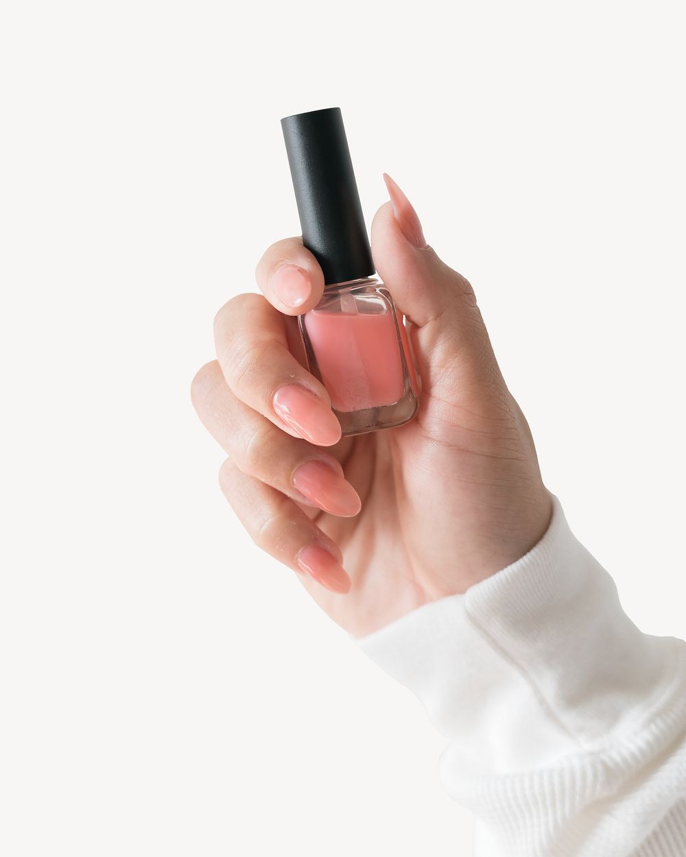 Woman holding pink nail polish bottle