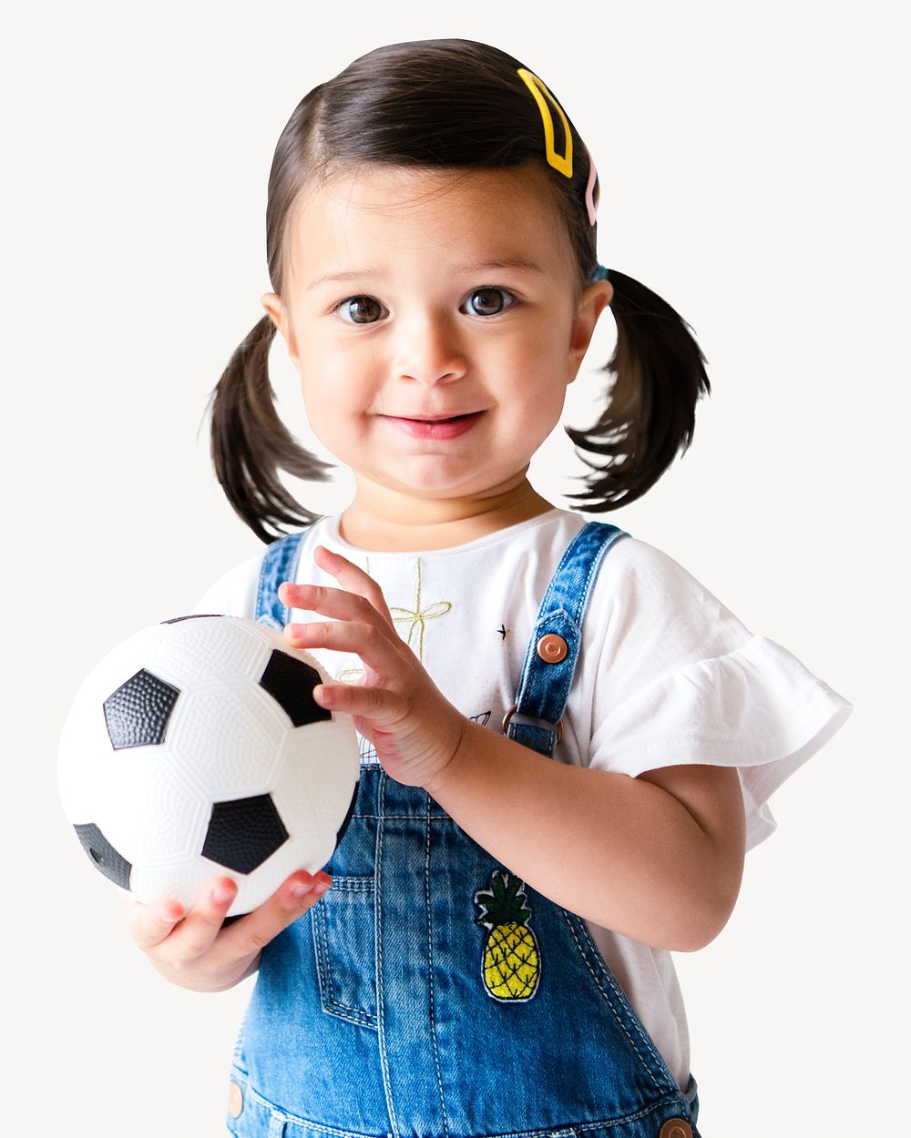 Happy little girl holding a football