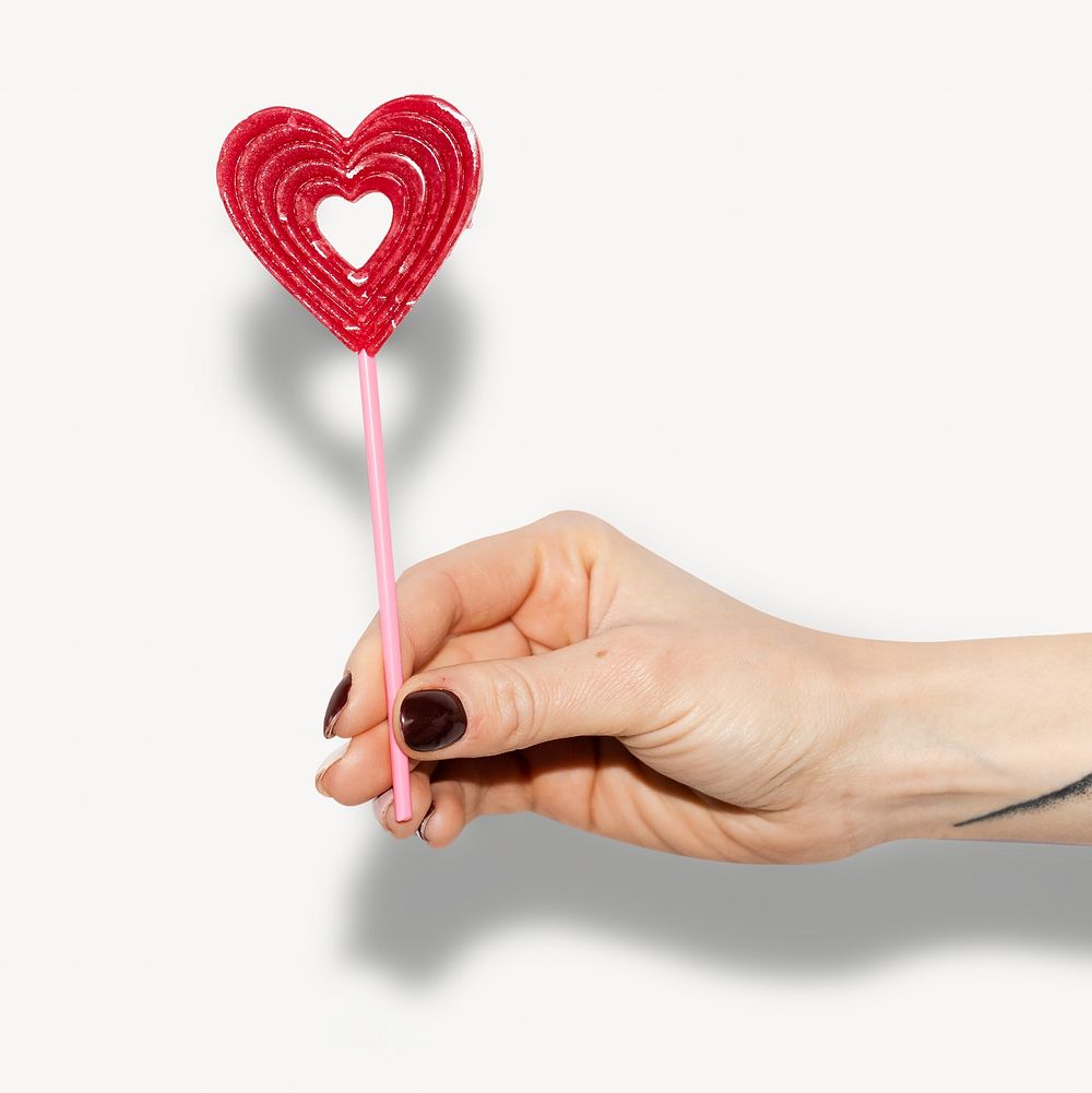 Hand holding lollipop isolated image