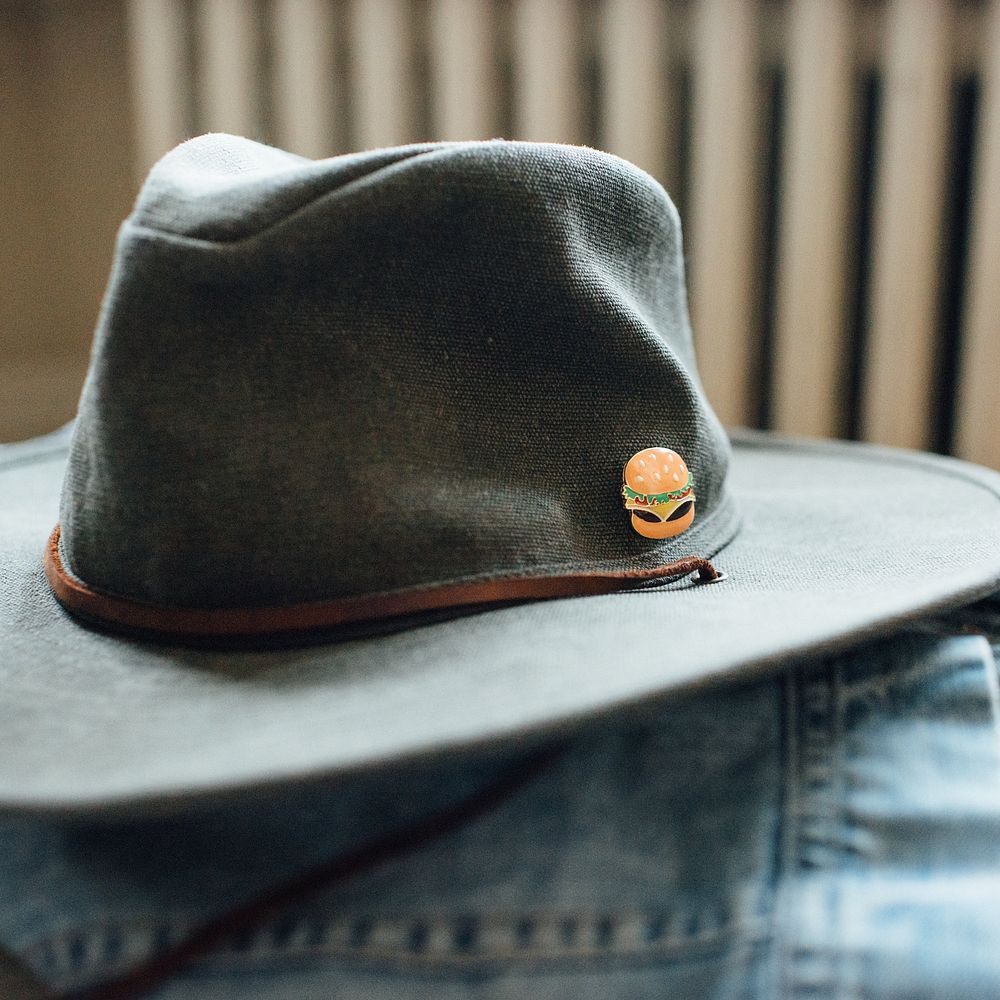 Cheeseburger enamel pin on hipster hat.