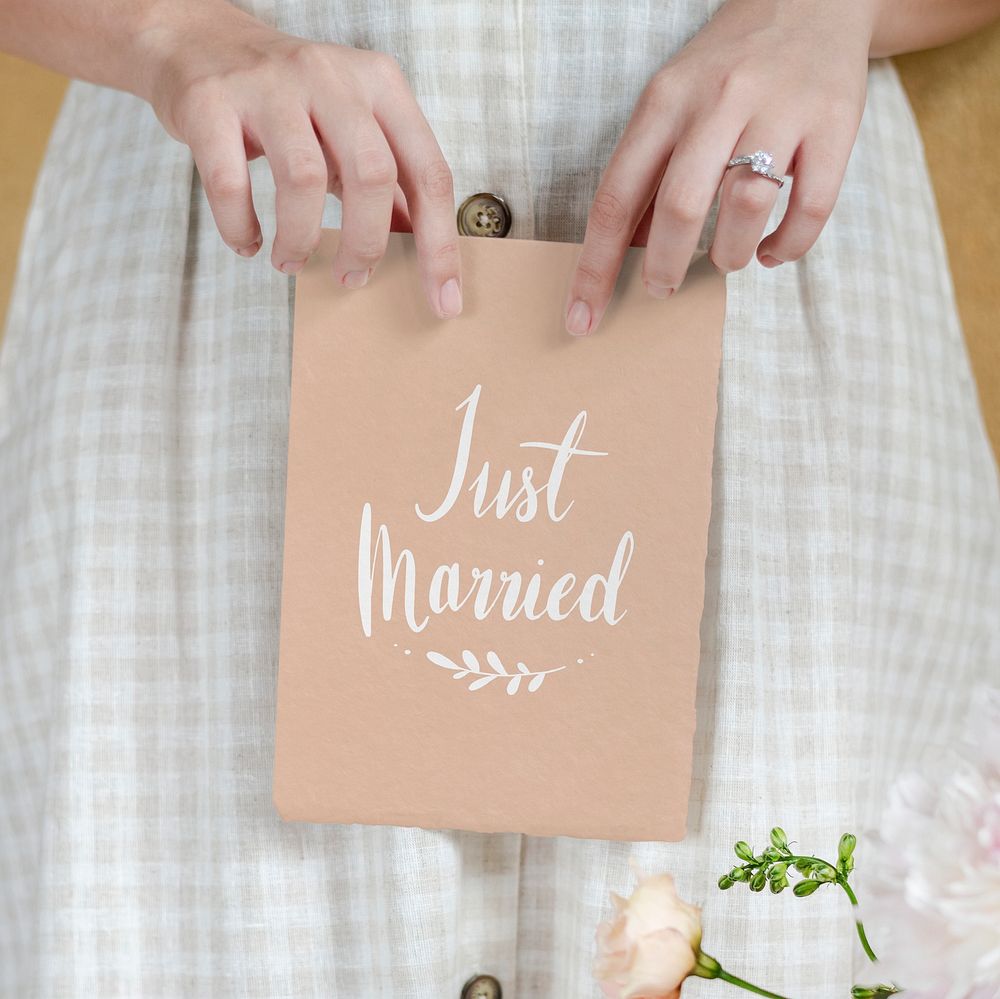 Bride holding a just married card mockup