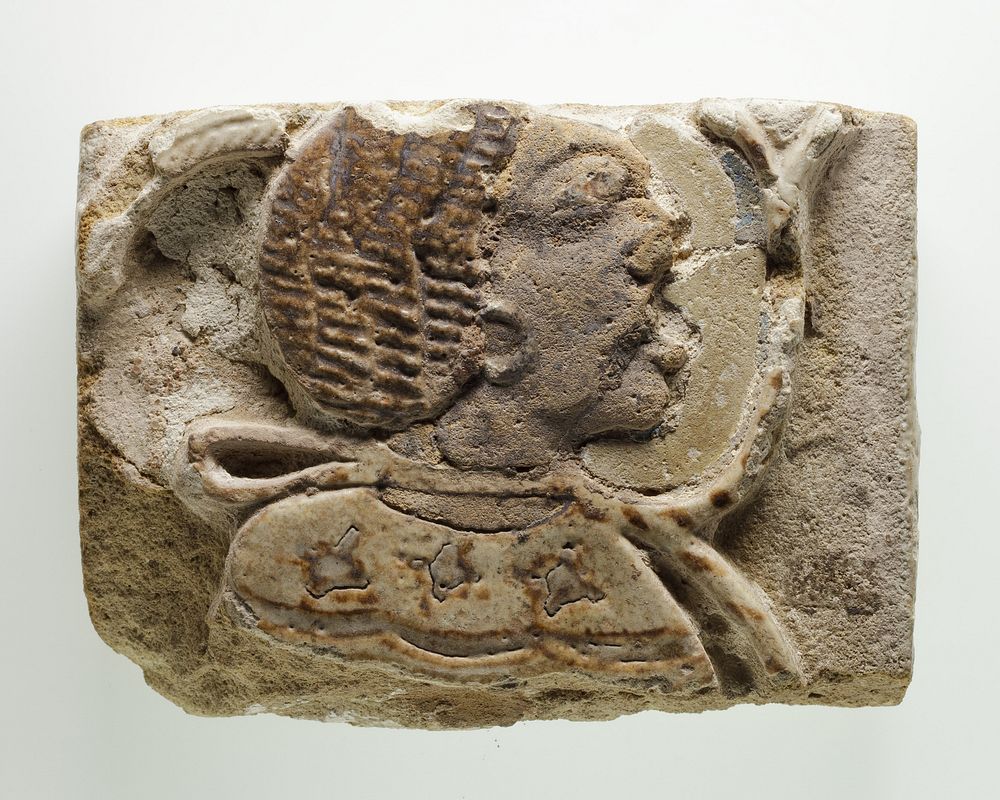 Tile fragment with a head of a prisoner