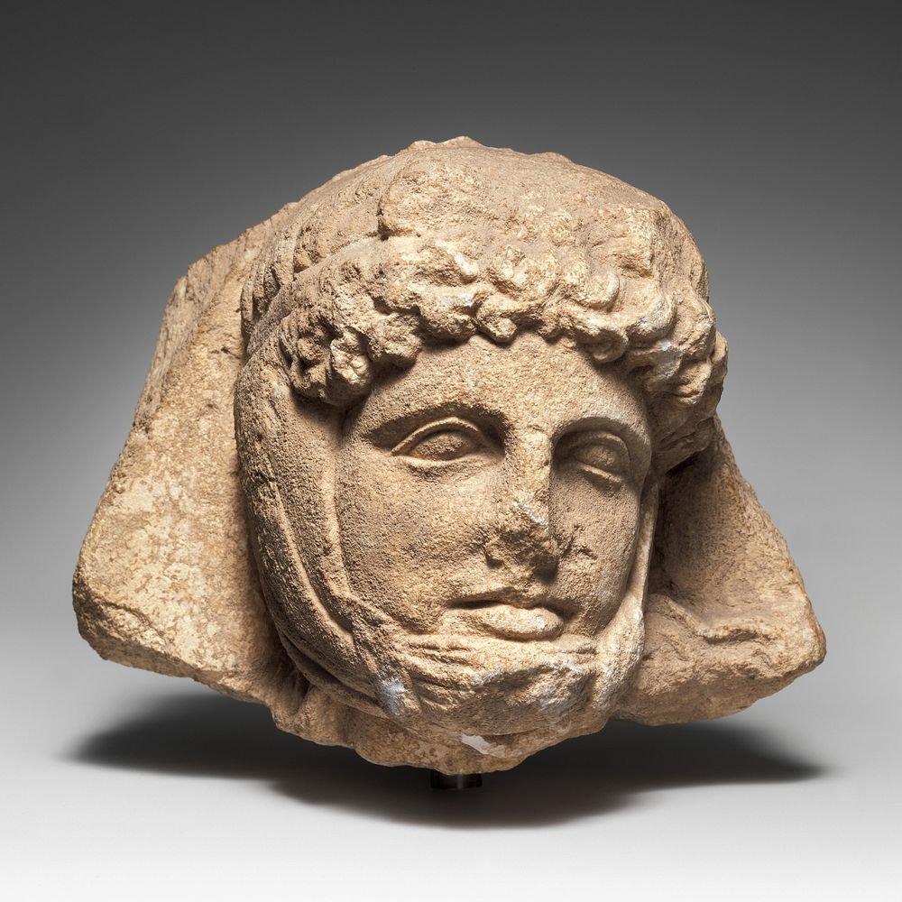 Limestone relief head of a Persian