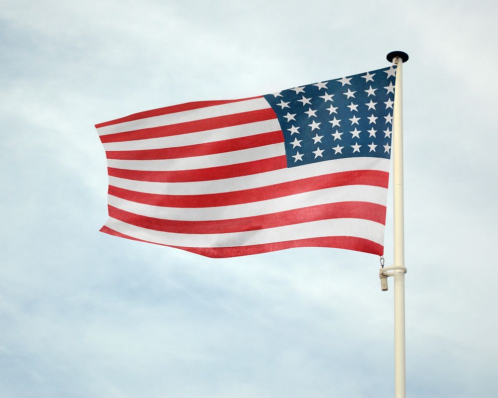 Waving USA flag against blue sky