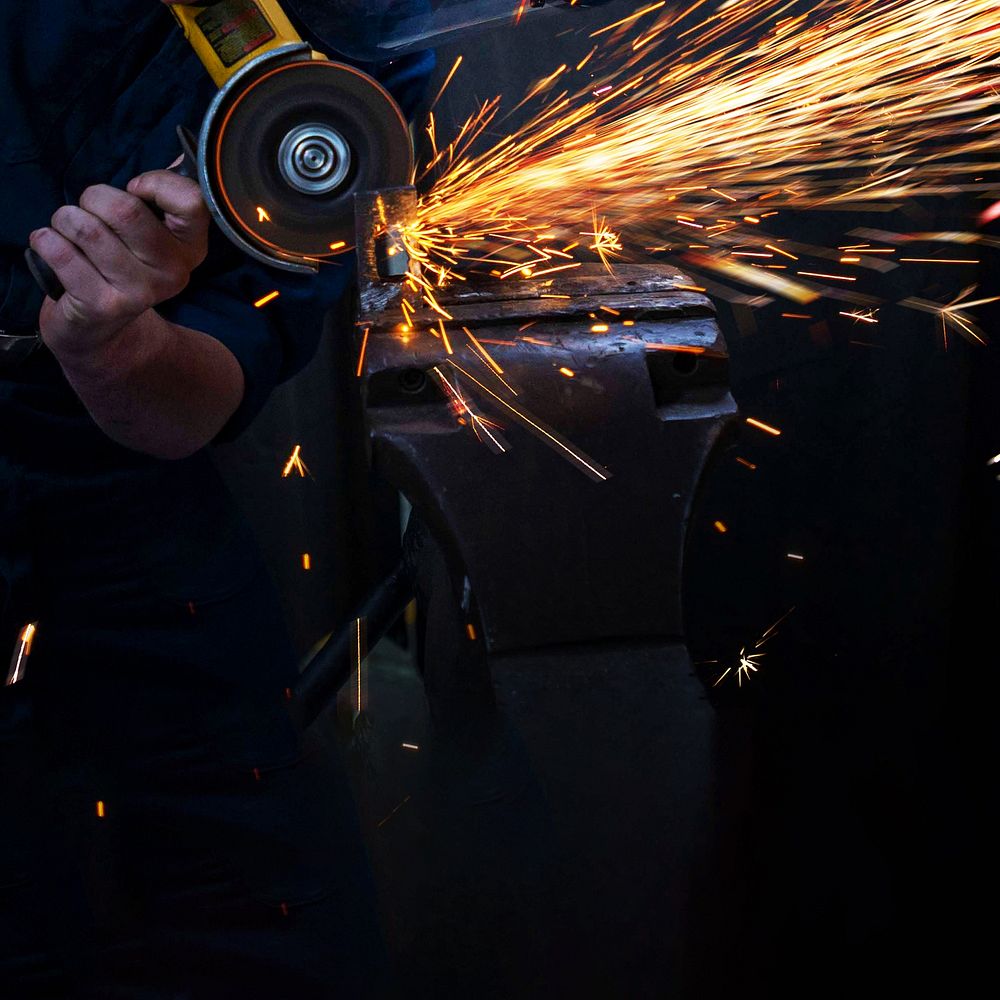 Man cutting metal with angle grinder