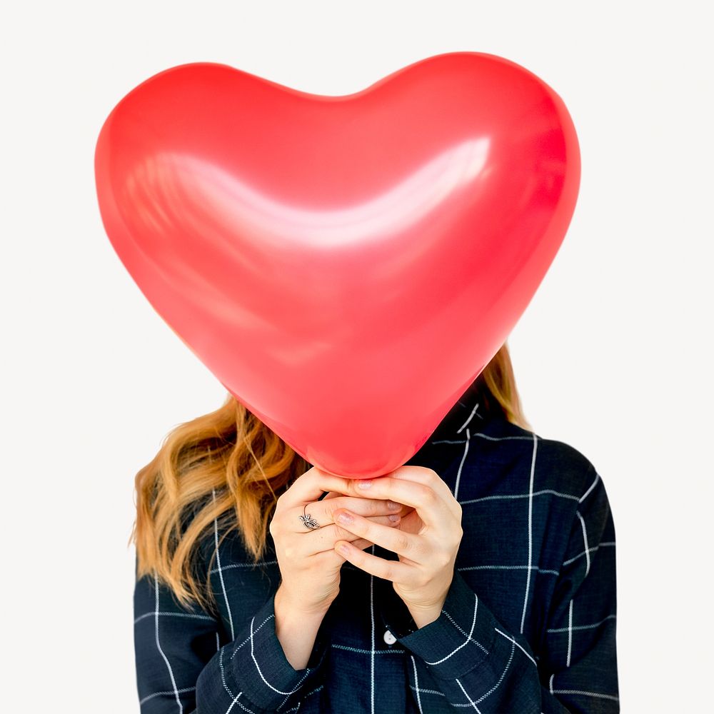 Woman with heart shaped balloon, face covered