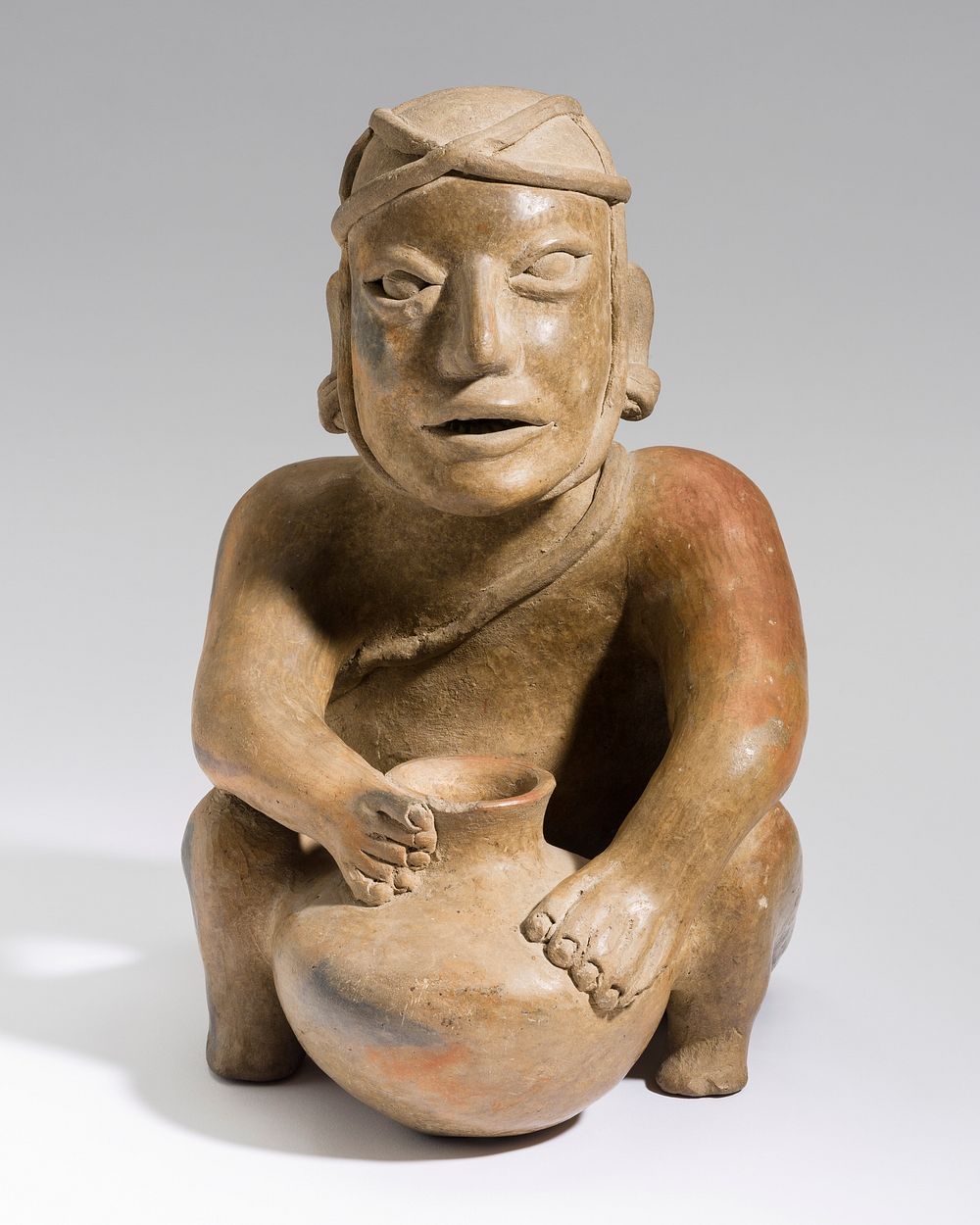 Crouching Male Figure with Jar