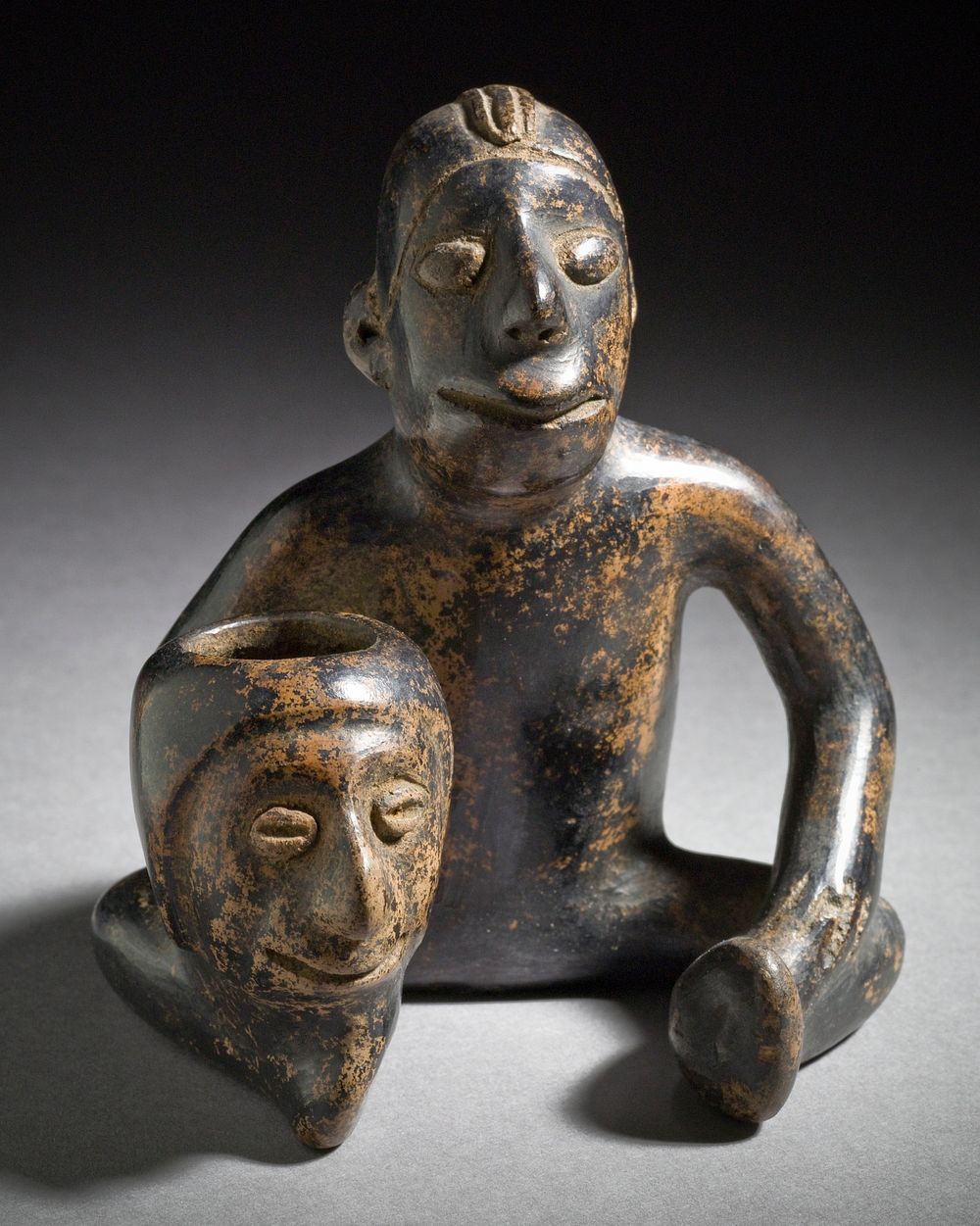 Seated Male Holding Head Vessel