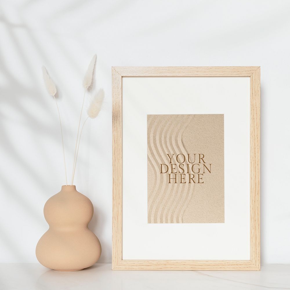 Wooden picture frame mockup psd with zen sand photo on the wall interior concept